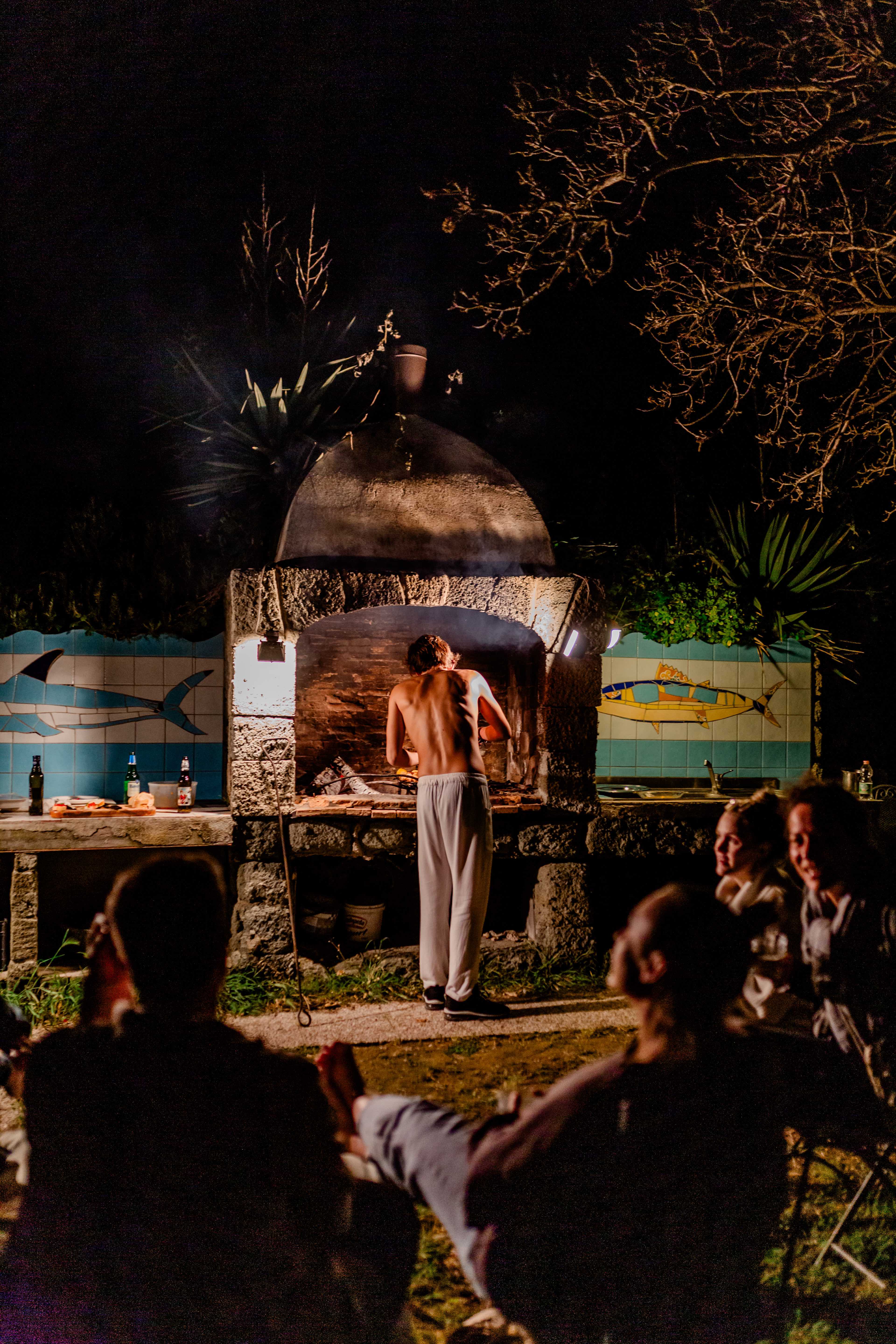 TripLeaders gathering around pizza oven